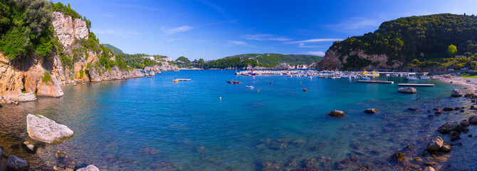 Fototapeta premium Beautiful summer seascape. View of the cliff into the sea bay with crystal clear azure water. Paleokastrica. Corfu. Ionian archipelago. Greece.
