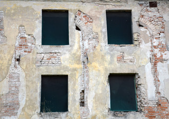 Fototapeta na wymiar Empty windows in abandoned building