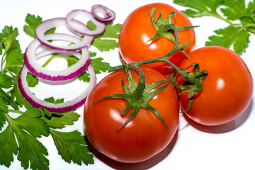 three red tomatoes on a branch
