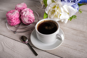 Black coffee and pink zephyr. marshmallow. Sweet pink marshmallow - zephyr and cup of Coffee. Christmas Still Life. Winter drink theme. Romance. Provencal still life. Good morning