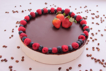 Cake souffle, covered with chocolate, berries, raspberry, blueberry, blueberry, strawberry, white background