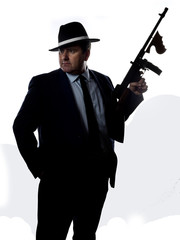 Old style gangster with machine gun, on white background