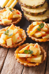 Tart filled with fresh pineapple and jam closeup. vertical