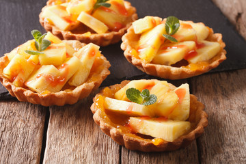 Freshly baked Tart with pineapple, jam and mint close-up. horizontal