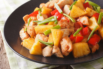 Chinese food: fried chicken with pineapple in sweet and sour sauce close-up. horizontal