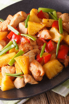 fried chicken with pineapple in sweet and sour sauce close-up. Vertical