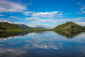 Fototapeta na wymiar Beautiful scenery of Skadar Lake with reflection of mountains an