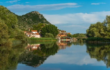 Fototapeta na wymiar River landscape Dodosi town with reflection mountains in the ri