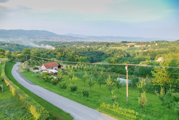 Rural forest landscape with high mountains in the background