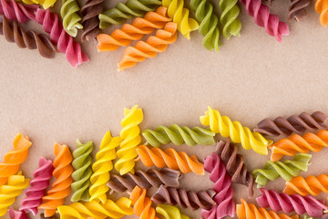 Background of colorful pasta texture close-up. Assortment of colorful macaroni. italian pasta. Variety of types and shapes of dry Italian pasta. Full background of dry uncooked macaroni.