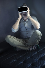 man with virtual reality glasses looking amazed