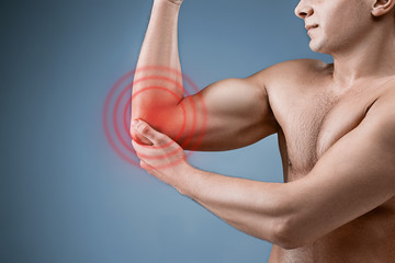 Fototapeta na wymiar Man With Pain In Elbow. Pain relief concept