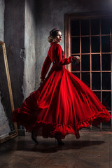 Young beautiful woman in dress on dark background