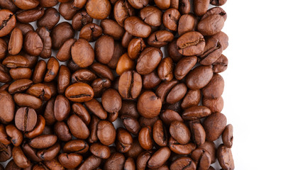roasted coffee beans isolated in white background. Roasted coffee beans background close up. Coffee beans pile from top on white background with copy space for text. Good morning.