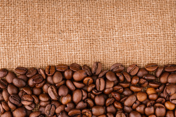 coffee beans on burlap background. roasted coffee beans isolated in white background. Roasted coffee beans background close up. Coffee beans pile from top on white background with copy space for text