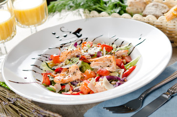 salad with fried salmon, pine nuts and parmesan