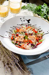 salad with fried salmon, pine nuts and parmesan