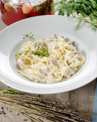 tagliatelle carbonara with bacon, cream sauce and cheese Parmigi