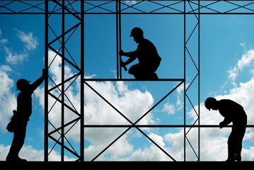 workers on a site silhouette with sky in background