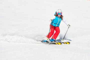 Fototapeta na wymiar Skier girl while ago slalom curves