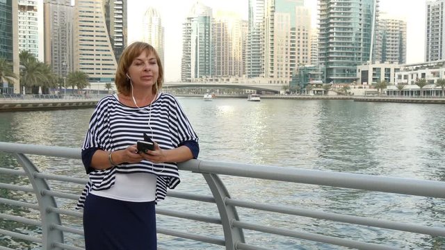 beautiful woman in white headphones  in Dubai Marina, UAE 
