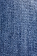 Naklejka premium Denim jeans texture background with torn. The texture of the colored cotton fabric. Stitched texture jeans background. Fashion jeans button. Pocket and rivet on jeans. Fiber and fabric structure.
