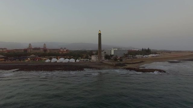 Aerial view of Maspalomas Lighthouse and resort on the coast of Gran Canaria. Evening scene