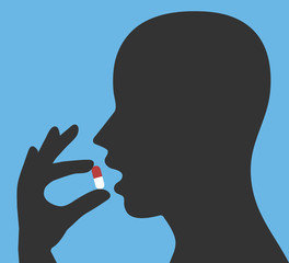 Taking the medicine capsule concept. Head with open mouth and a hand holding medical pill
