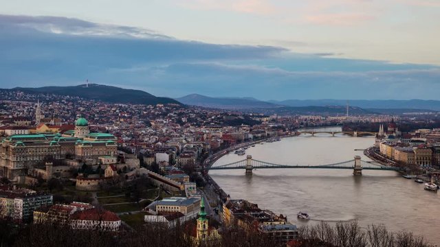 Aerial view of Budapest, Hungary with clouds running at a fast pace. Buda castle, Chain bridge and Parliament building. Time-lapse