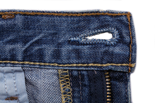 Denim jeans texture background with torn. The texture of the colored cotton fabric. Stitched texture jeans background. Fashion jeans button. Pocket and rivet on jeans. Fiber and fabric structure.