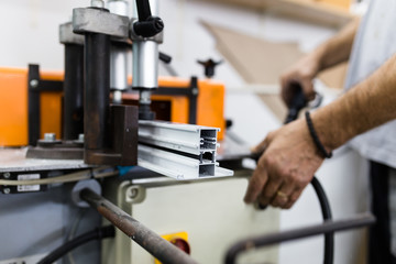 Manual worker assembling PVC doors and windows. Manufacturing jobs. Selective focus. Factory for aluminum and PVC windows and doors production.