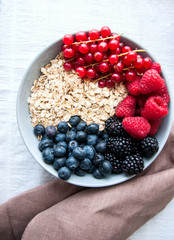 Big bowl of oat granola with berries. Breakfast concept.