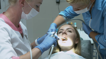 Patient for preventive medical checkup at dentist with probe and mirror