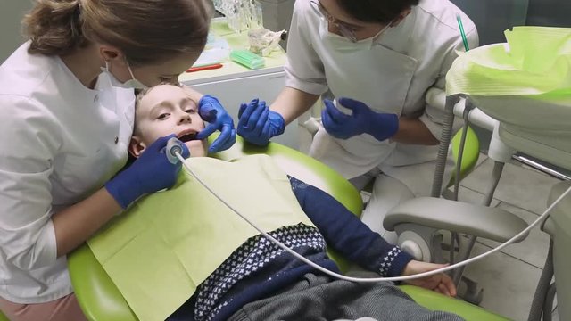 Dentists examine the patient's teeth treat tooth boy. Dental Camera. Close-up.

