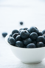 Blackberries in a white little bowl on a white background