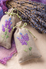 Bunch of lavender flowers and sachets filled with dried lavender.
