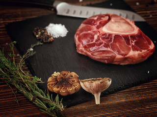 Raw ossobuco on a stone base for the meat.