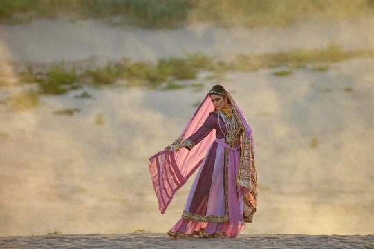 Young traditional Indian woman portrait on desert background,vintage style