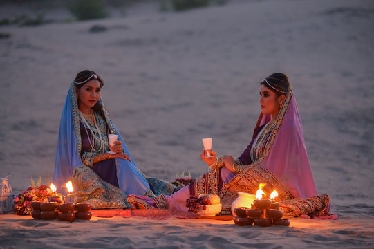 Young traditional Indian woman portrait on desert background after sunset ,vintage style