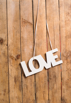 Wooden letters forming word LOVE written on wooden background