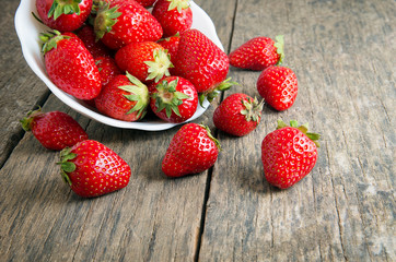 Ripe red strawberries on wooden table