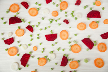 Background from cut beet,carrot,peas,onion.Top view