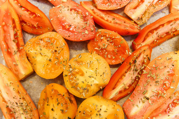 Yellow and red cut tomatos with herb spices.Food background.fod background.
