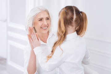 Cheerful woman and little girl clapping hands
