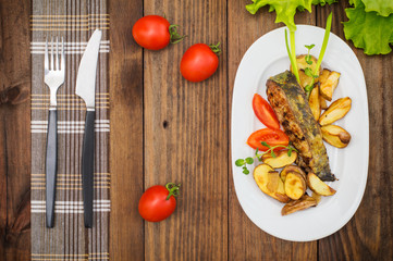 Deep Fried Dolly Fish Steak with French fries on wood background. Top view. Close-up