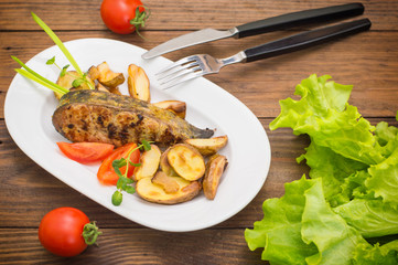 Deep Fried Dolly Fish Steak with French fries on wood background. Top view. Close-up