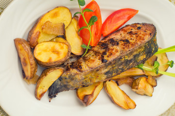 Deep Fried Dolly Fish Steak with French fries on wood background. Top view. Close-up