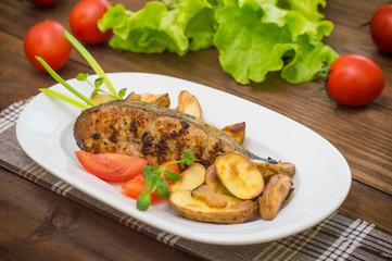 Deep Fried Dolly Fish Steak with French fries on wood background. Top view. Close-up