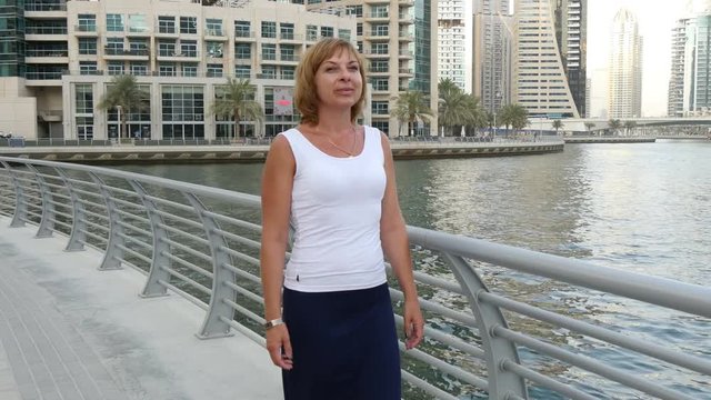 beautiful woman walking on the waterfront in Dubai 