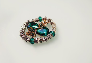 The bracelet and earrings stand on the table